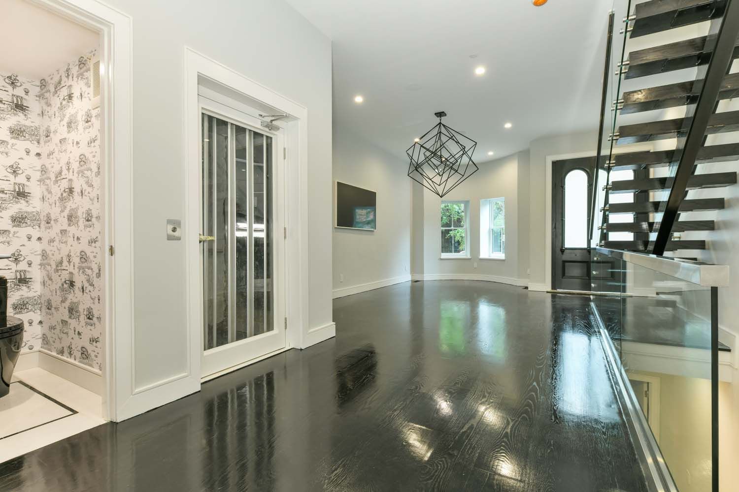 hallway with dark floors and white walls