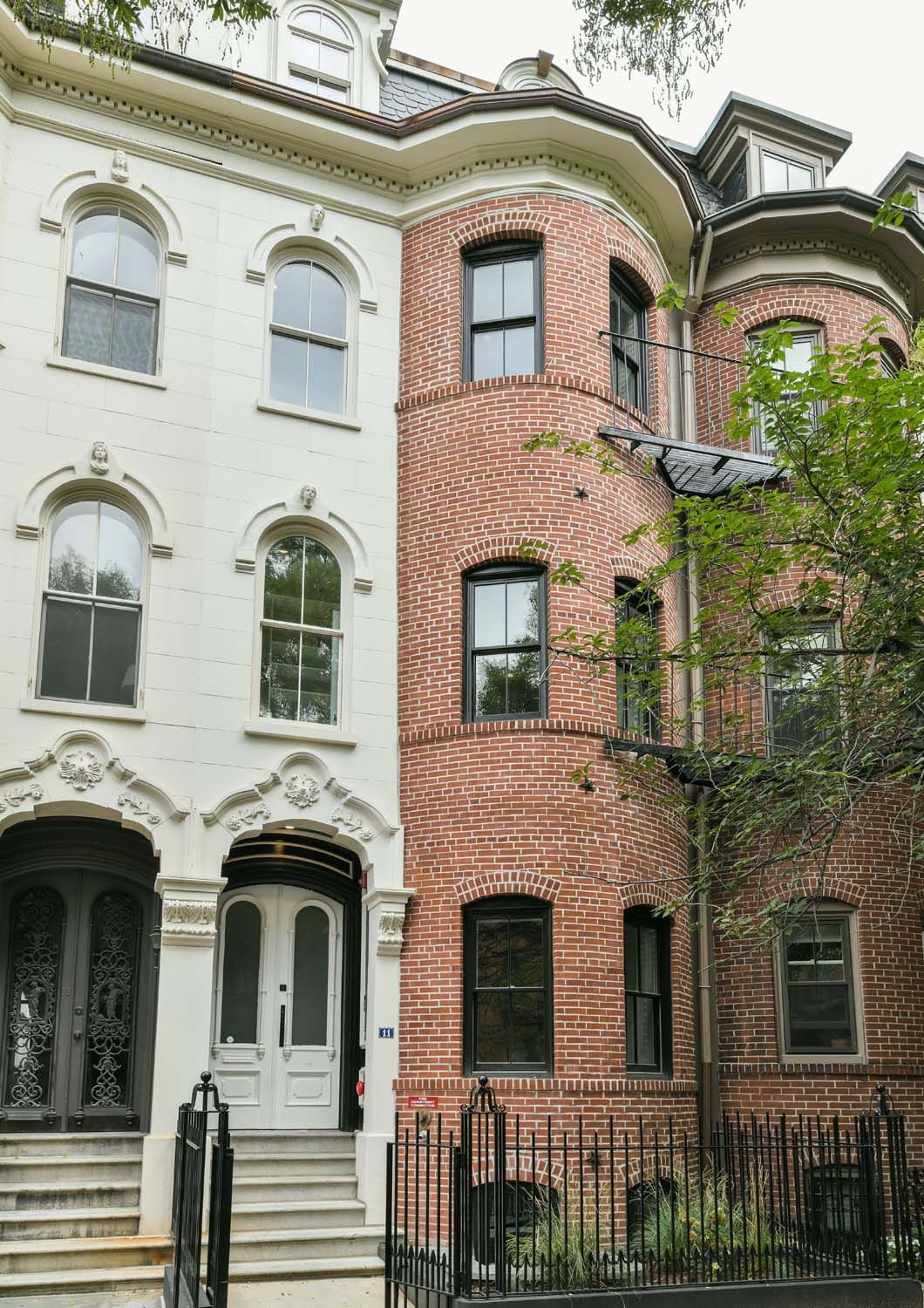 exterior of white building and brick buildings